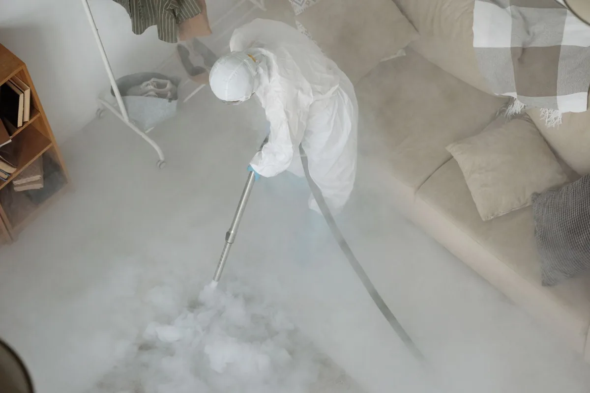 Biohazard cleanup technician in protective equipment, Helper, UT